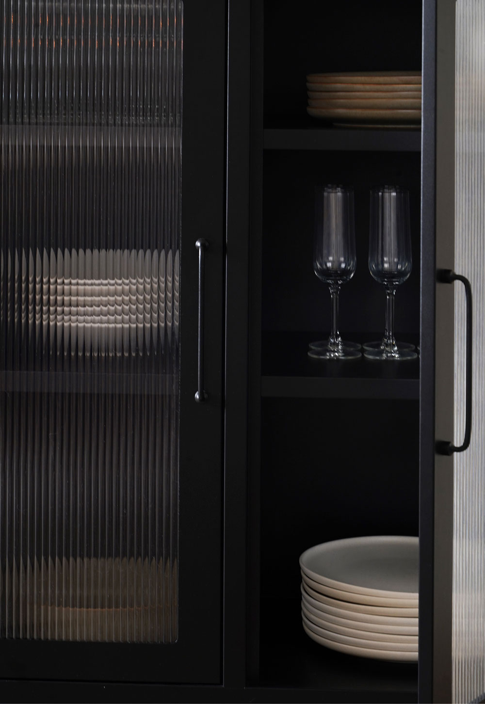 Black reed-fronted display cabinet from Bisley, with rustic-minimalist beige tableware and glassware inside | These Four Walls blog