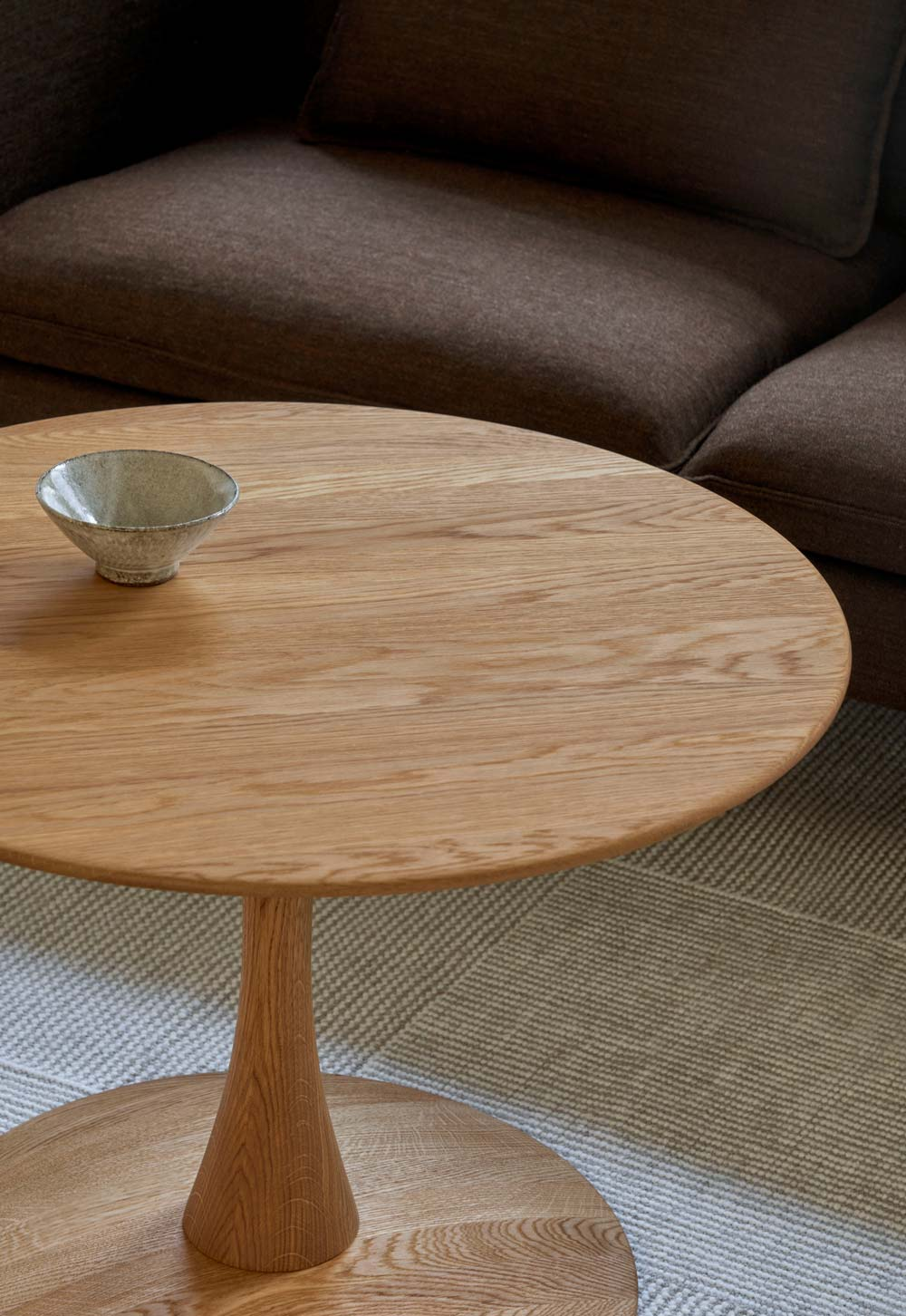 Minimalist living room with brown sofa and circular oak coffee table from Frederica's 'Trisse' collection, designed by Nanna Ditzel | New design finds - July 2026 | These Four Walls blog