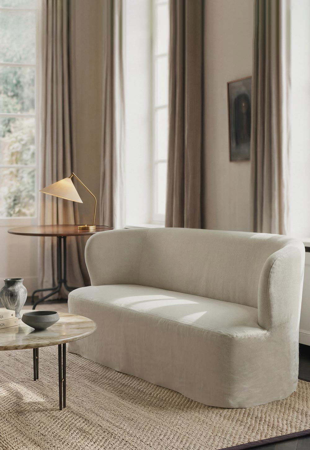 Calm neutral living room with marble coffee table, natural materials and beige linen slipcover sofa from GUBI's 'Stay' collection | New design finds - July 2026 | These Four Walls blog