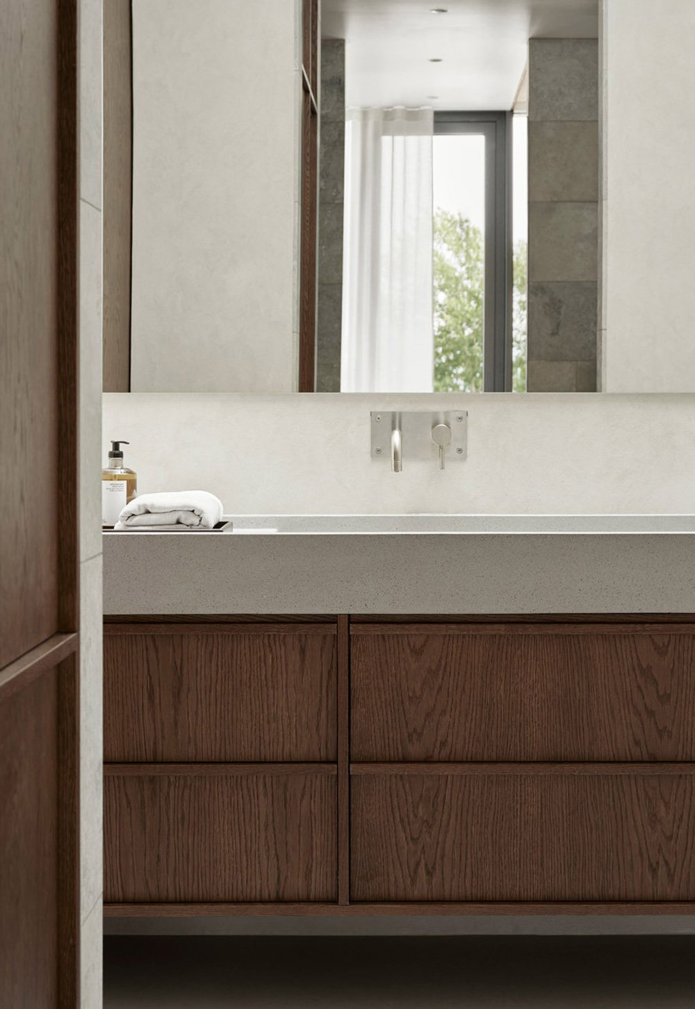 Minimalist bathroom with stone basin and dark wood vanity unit and cupboard from Nordiska Kök's new 'Bath' collection | New design finds - July 2026 | These Four Walls blog