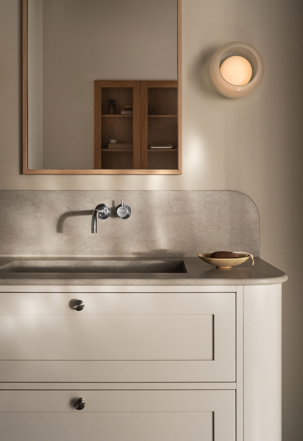 Minimalist bathroom with limestone basin and beige Shaker vanity unit with rounded edges from Nordiska Kök's new 'Bath' collection | New design finds - July 2026 | These Four Walls blog