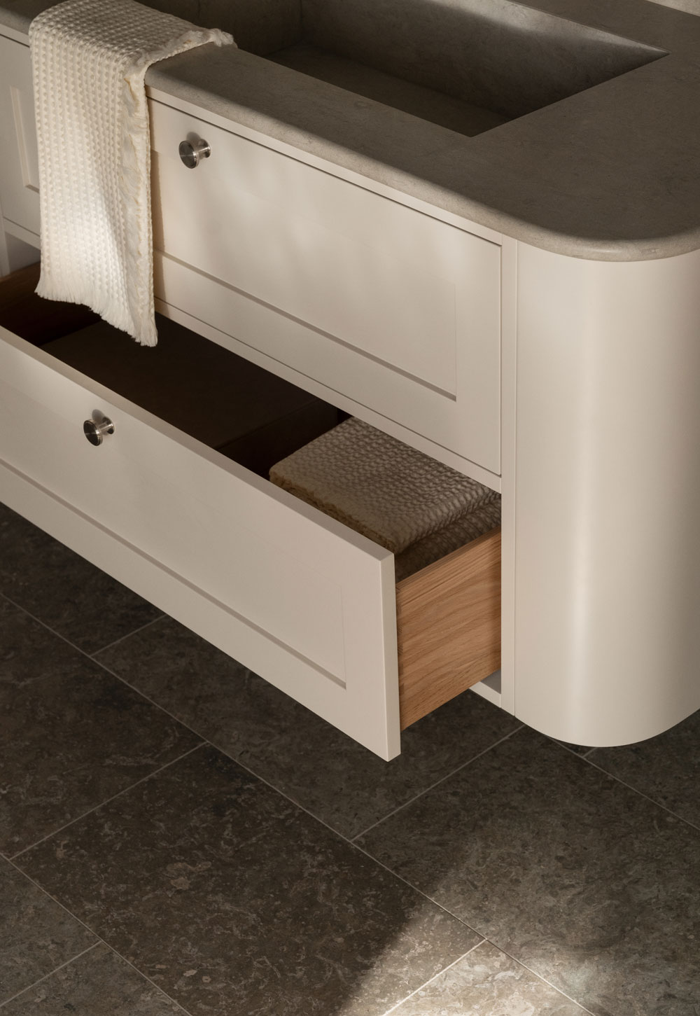 Minimalist bathroom with limestone basin and beige Shaker vanity unit with rounded edges from Nordiska Kök's new 'Bath' collection | New design finds - July 2026 | These Four Walls blog