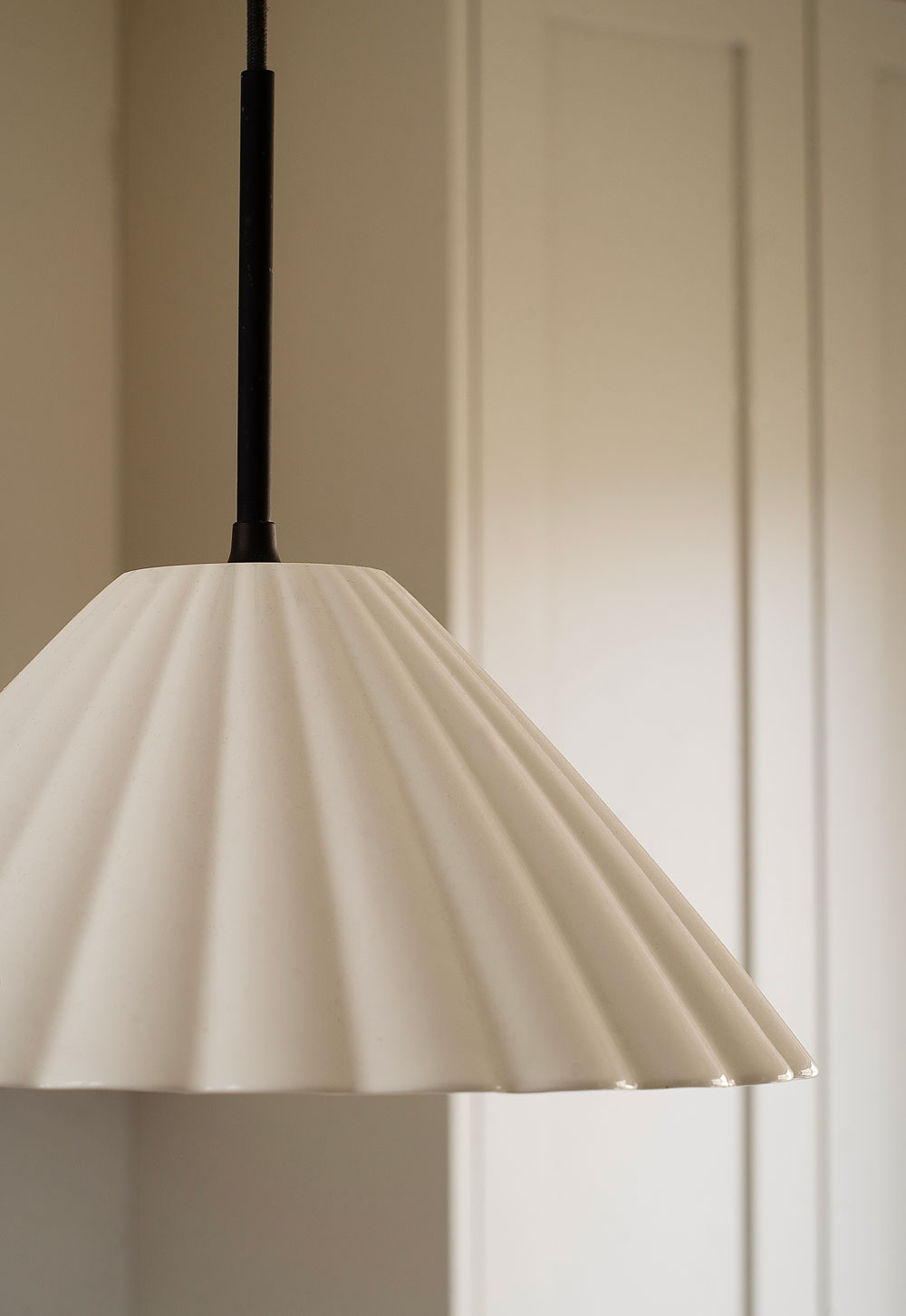 Scalloped ceramic and bronze pendant light in a minimalist cottage kitchen | These Four Walls blog