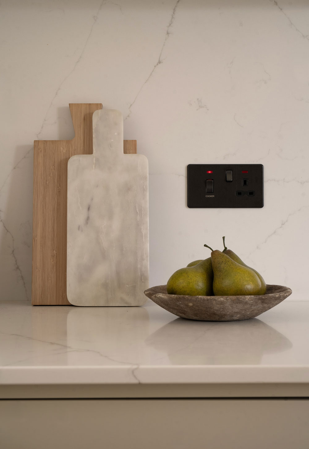 Marble worktop and splashback, rustic bowl and wooden and marble serving boards in a minimalist cottage kitchen | These Four Walls blog