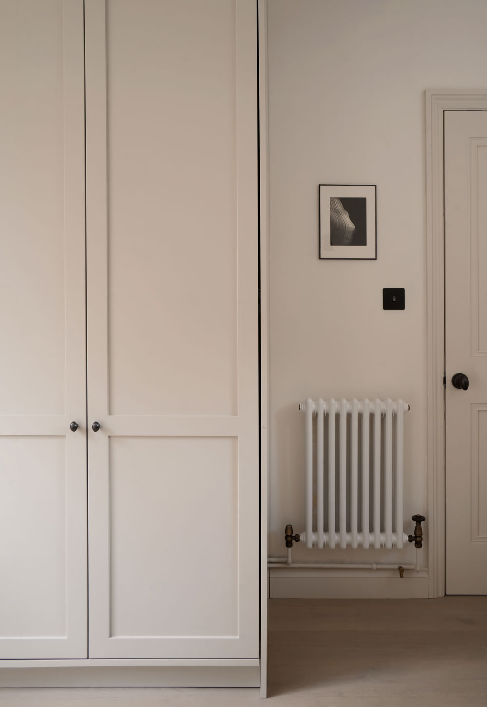 Minimalist cottage kitchen with beige Shaker units and oak flooring | These Four Walls blog