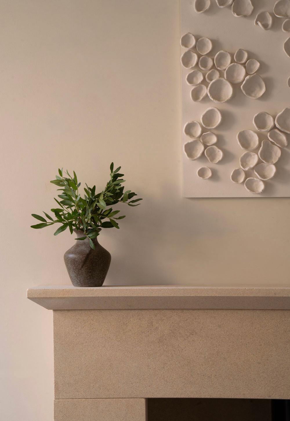 Bath-stone fireplace in a neutral cottage interior | These Four Walls blog