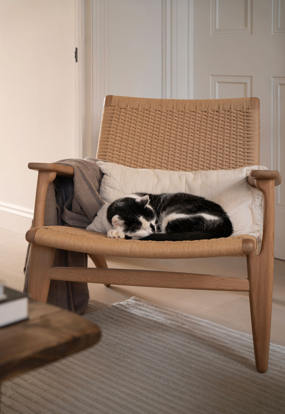 Carl Hansen oak and paper-cord CH25 chair in a minimalist cottage living room | These Four Walls blog